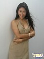 Arms folded under breasts long black hair falling over shoulder