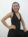 Asian shemale benz posing in black dress hand on hip right hand resting on thigh