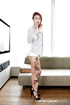 Standing beside sofa in shorts wearing high heels