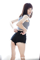 Looking over her shoulder adjusting shorts